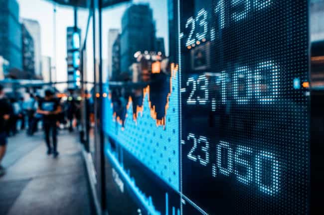 image of stock exchange numbers reflecting through a window on the street